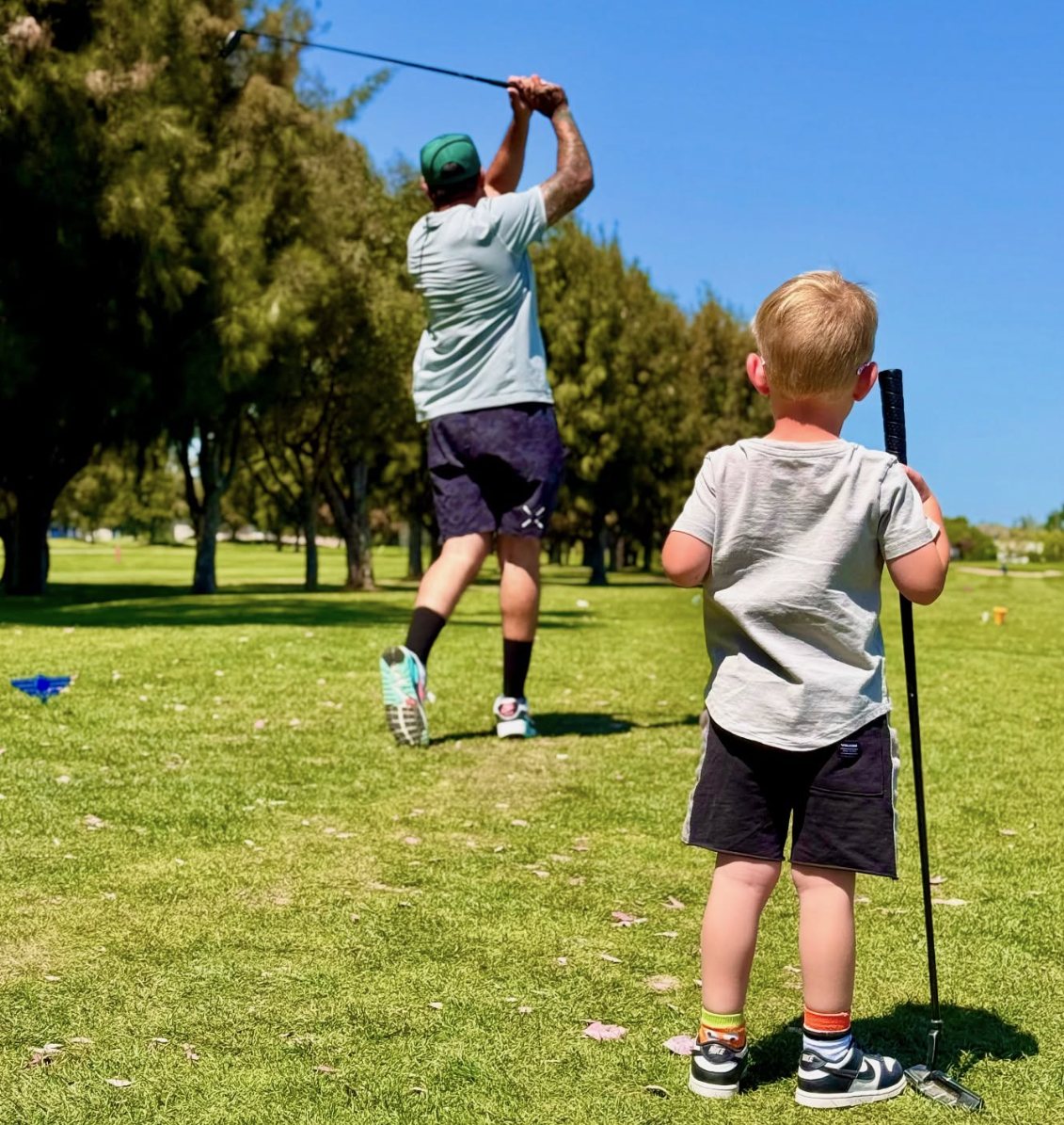 A dad and his son playing golf at Skylinks
